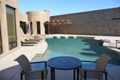 Luxury Pool Formal Design with Glass Tile Tanning Ledge